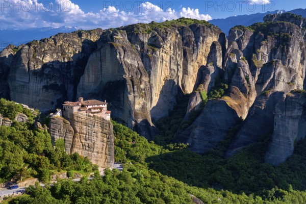 View of Meteora valley, Greece at midday. Clifftop Moni Agias Varvaras Roussanou nunnery among