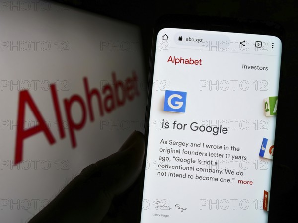 Stuttgart, Germany, 10-30-2022: Person holding cellphone with webpage of US holding company