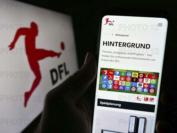 Stuttgart, Germany, 12-07-2023: Person holding cellphone with webpage of German football company