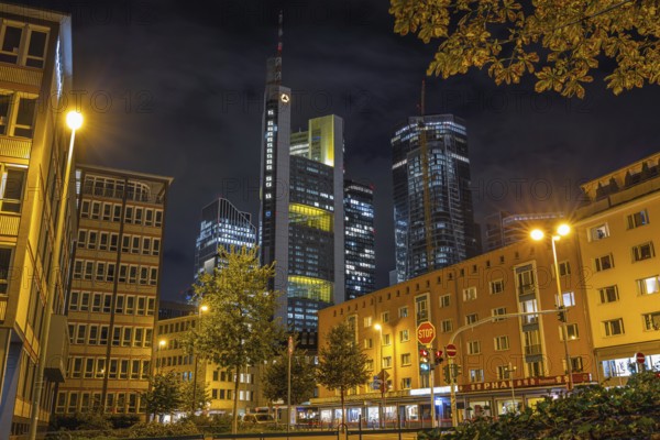 Clouds pass over the shining Commerzbank Tower in the dark evening sky, Rossmarkt, Frankfurt am