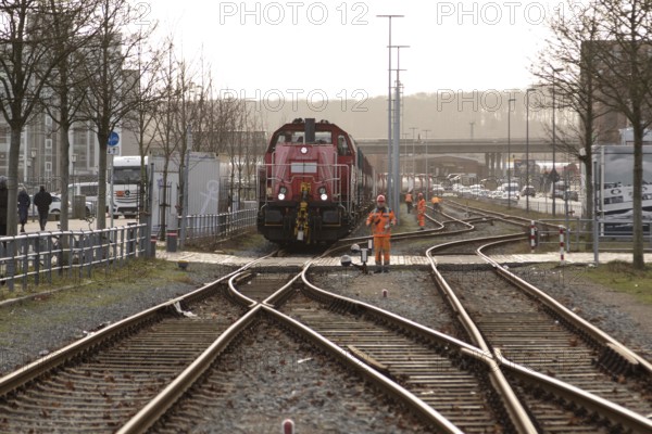 Symbolic image logistics, freight transport, railway tracks with locomotive and freight wagons of
