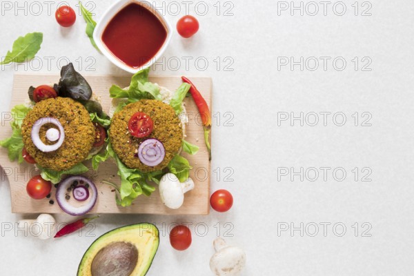 Flat lay vegan burgers wooden board with copy space