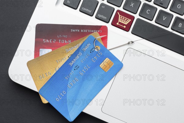 Top view laptop with credit card phishing hook
