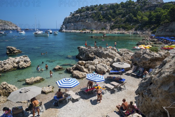 Beach umbrellas and sunbeds, turquoise waters, Anthony Quinn Bay, Faliraki, Rhodes, Dodecanese,