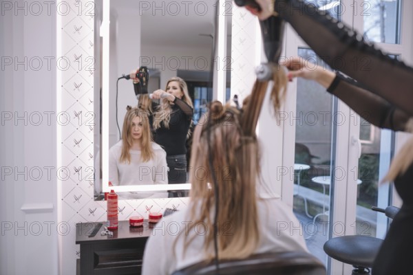 Hairstylist using brush dryer
