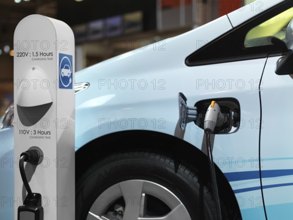 Electric car recharging batteries at a charging station