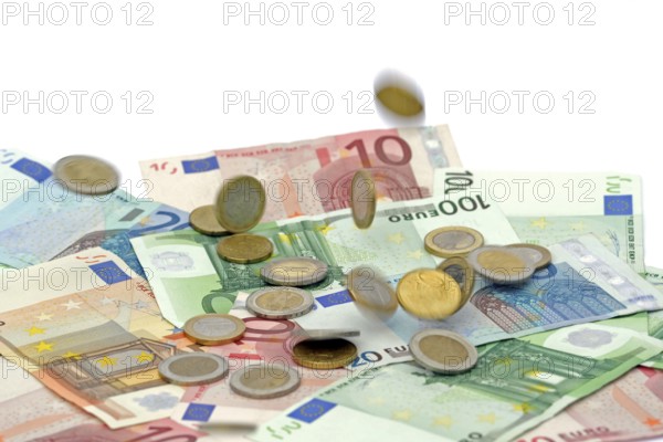 Euro coins fall on euro banknotes, rain of money, high cost, symbolic image