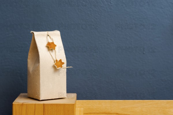 Selfmade gift box out of old beverage carton decorated with star shaped cut out dried roange peel
