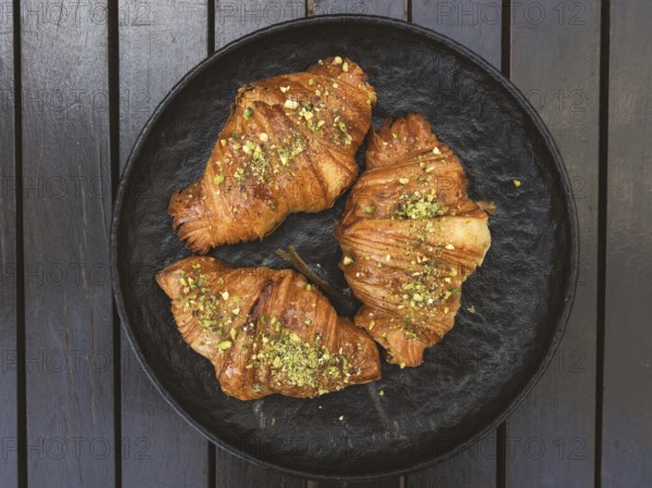 High angle view of three croissants with pistachios on top of them