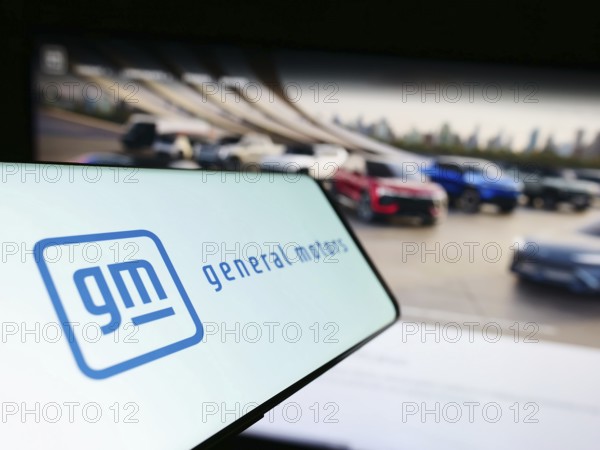 Stuttgart, Germany, 07-01-2023: Cellphone with logo of US car manufacturer General Motors Company