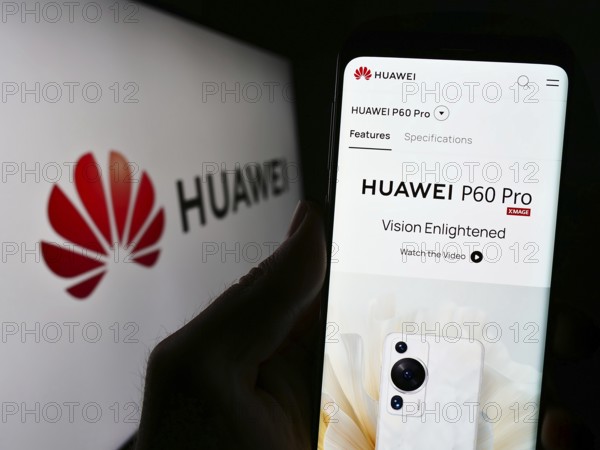 Stuttgart, Germany, 07-15-2023: Person holding cellphone with website of Chinese company Huawei