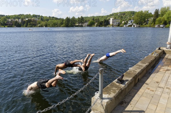 Summer, boys jumping into a lake, Saint Agathe, Province of Quebec, Canada, North America