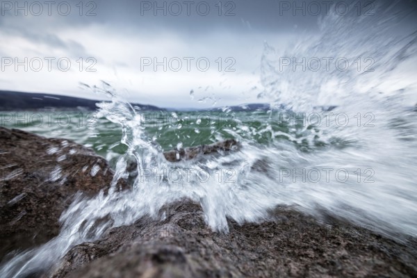 Stormy waves crash against rocks and create impressive splashing water, harbour, Mittelzell,