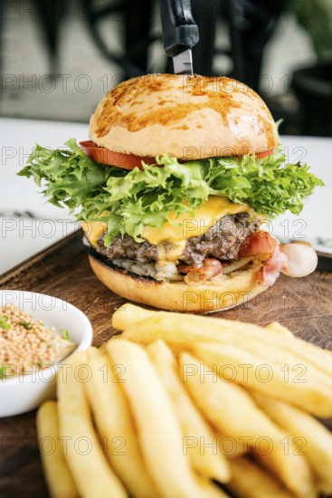 Beef burger with fries and mustard sauce set snack meal