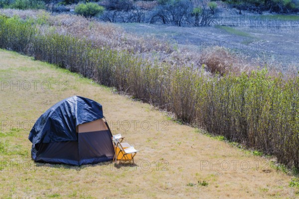 One man tent pitched in field in countryside in South Korea