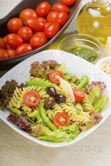 Fresh healthy homemade italian fusilli pasta salad with parmesan cheese, pachino cherry tomatoes,