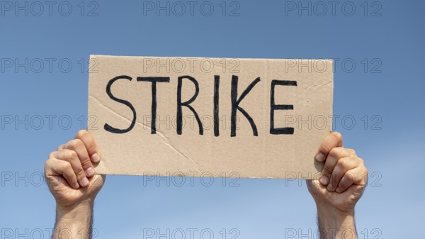 Protester holding board with strike