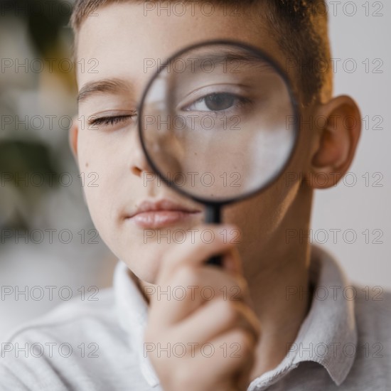Portrait boy using magnifier class