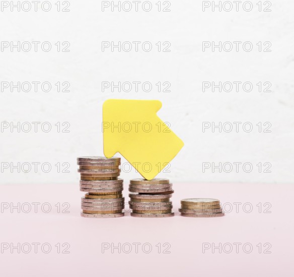 Pile coins arrow pointing up