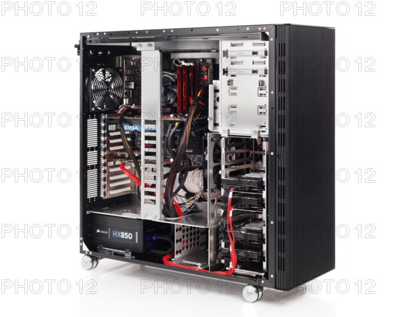 PC computer open ATX case with motherboard and other hardware installed isolated on white