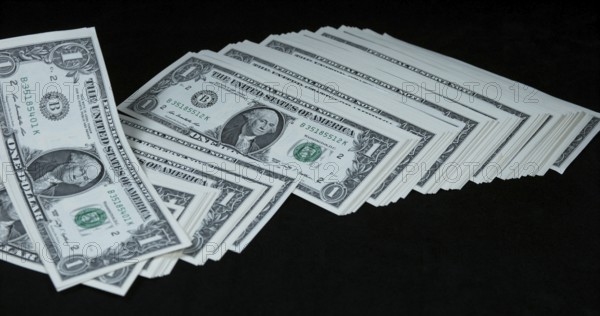 1 US Dollar Banknotes falling against Black background