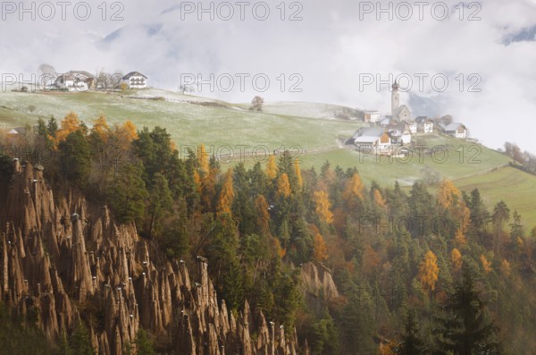 Church of St. Nicholas in Mittelberg at Renon, with the Rittner Erdpyramiden fairy chimneys of