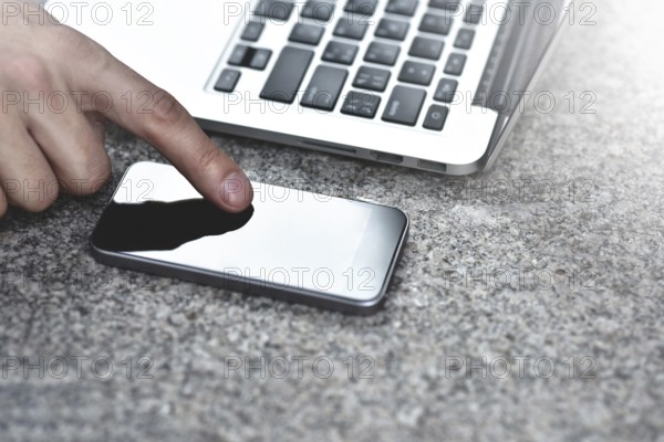 Cropped image of young woman downloading applications and multimedia programs by mobile smartphone,