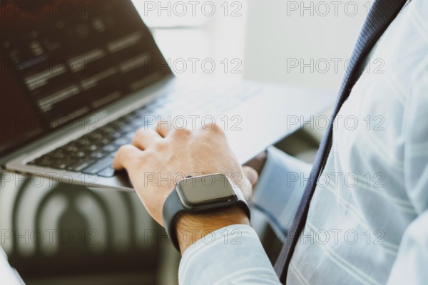 In this photo, man surfing the internet through an Apple MacBook, researching the stock price on