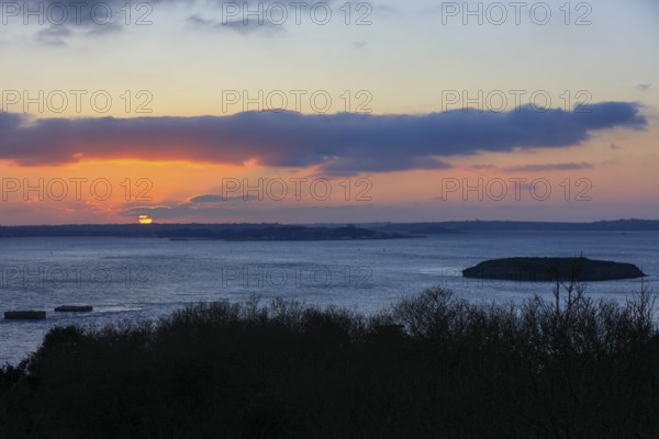 View at sunset from the Pointe de l'Armorique over the bay Rade de Brest with the small island Ile