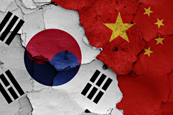Flag of South Korea and China painted on cracked wall