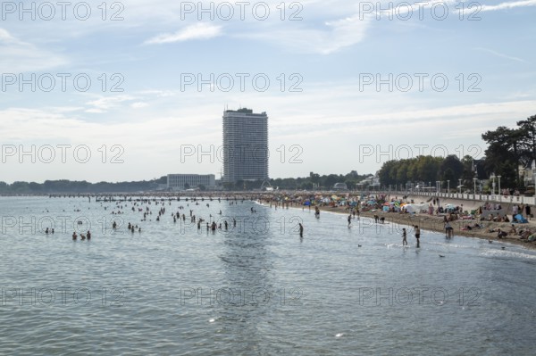 Symbolic picture weather, summer, bathers on the sandy beach at the Baltic Sea, in the background