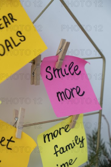 SMILE MORE self care goal on Action board new year's resolutions on colorful sticky notes. Making
