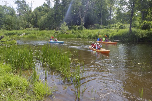Kayaking on the river, three kayaks go on the river, Angrapa river, Kaliningrad region, Russia,
