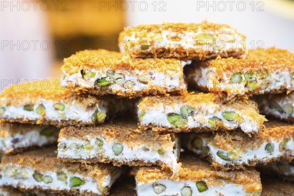 Turkish traditional dessert Kadayif baked in syrup served with nut powder