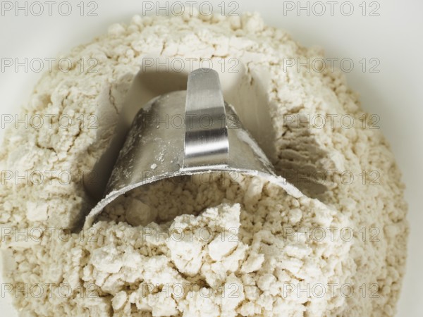 Measurement tool in a bowl of wheat flour