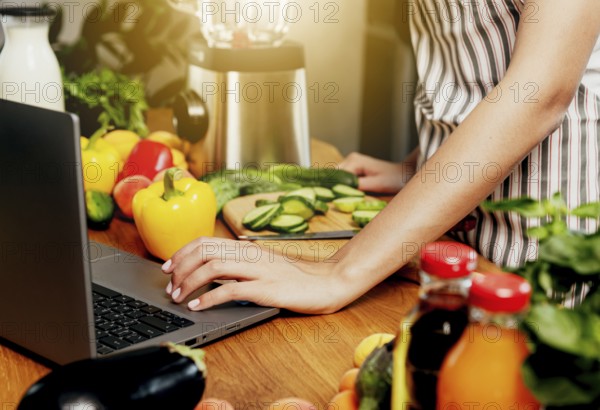 Young woman using laptop computer, girl hand clicking, touching pc. Person looking for recipe or
