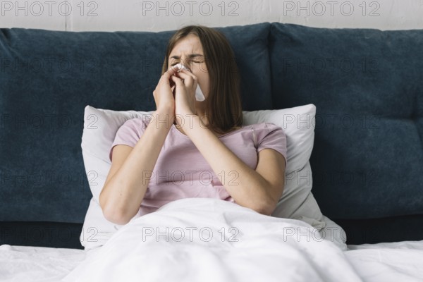 Pretty woman lying bed suffering from cold