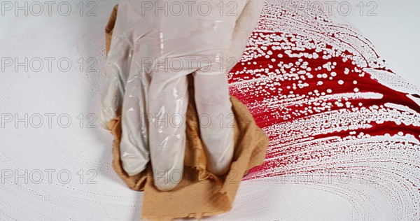 Gloved hand that wipes blood against White Background