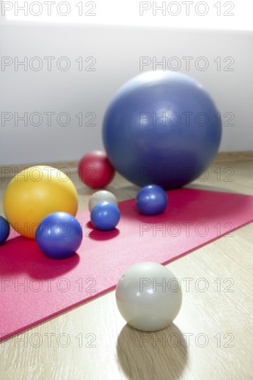 Balls stability and toning pilates sport gym on red yoga mat