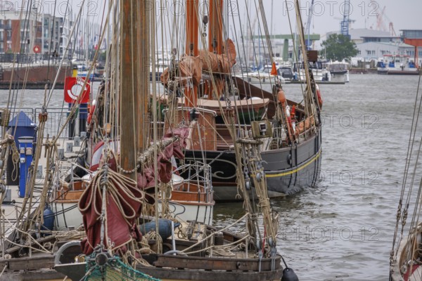 Several old sailing boats are moored close together in the harbour, Bremerhaven, Bremen, Germany,