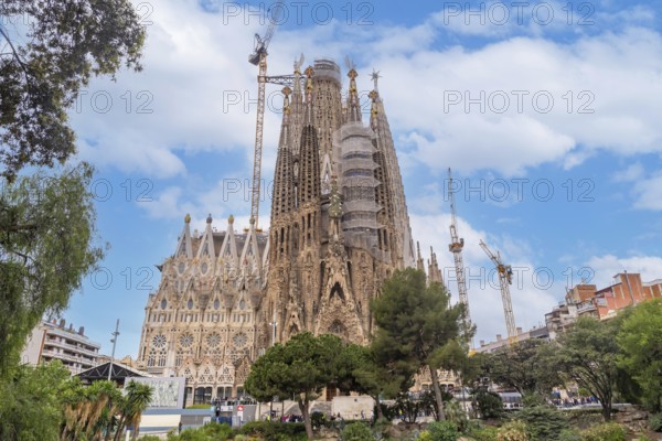 Basilica of the Sagrada Familia in Barcelona by the lake on a spring morning, Spain, Europe