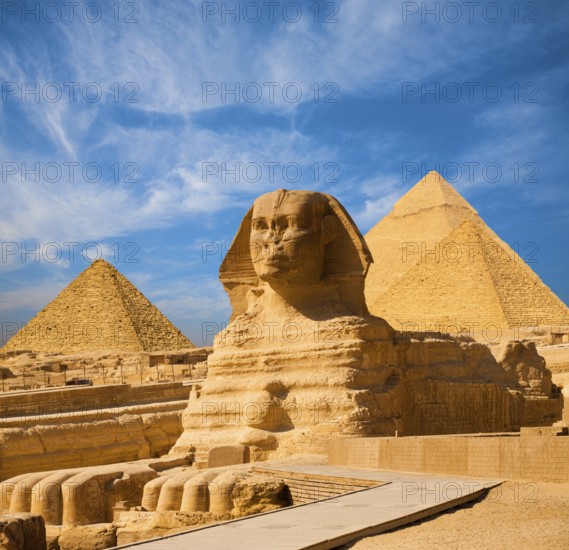 Egyptian Great Sphinx full body portrait with head, feet with all pyramids of Menkaure, Khafre,