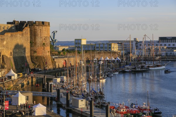 Sailing boats in front of the Chateau de Brest fortress at the mouth of the river Penfeld into the