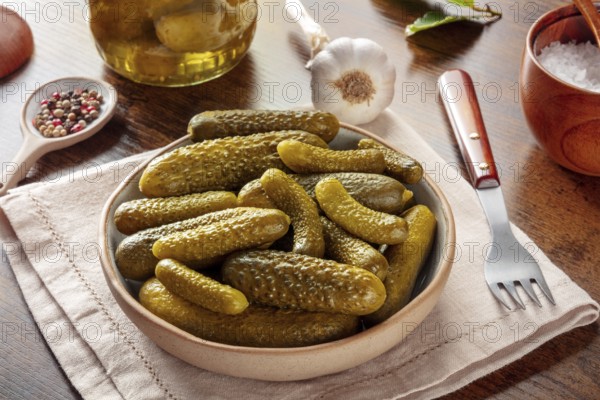 Pickled cucumbers with salt, pepper, garlic, and bay leaf. Fermented food. Homemade canned gherkins