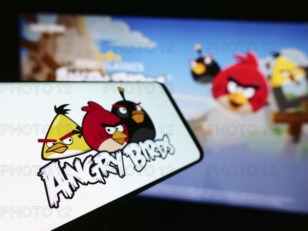 Stuttgart, Germany, 11-14-2023: Smartphone with logo of artillery video game Angry Birds in front