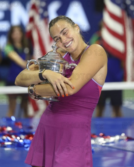 Tennis player Aryna Sabalenka hugging the trophy during the presentation at the US Open 2024
