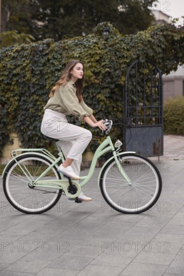 Side view woman city riding bicycle