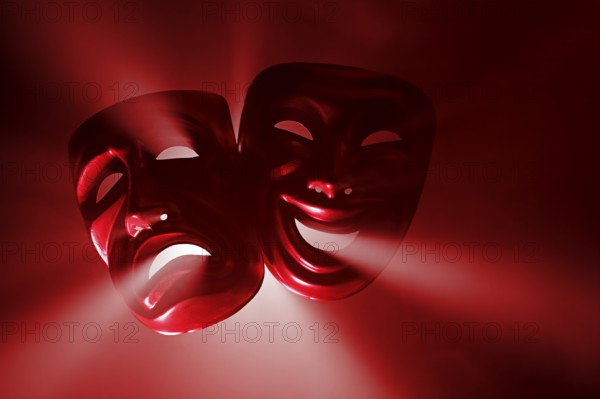 Crying and smiling masks in hazy light