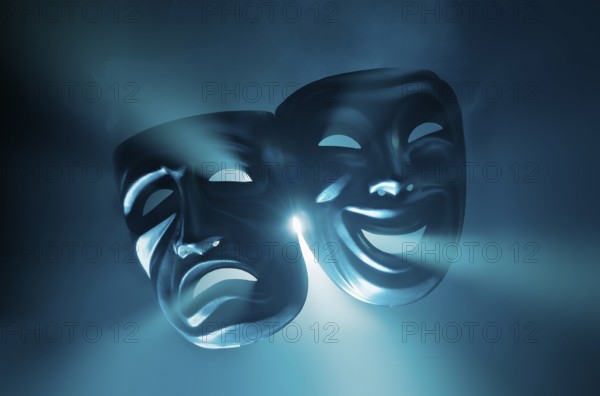 Crying and smiling masks in hazy light