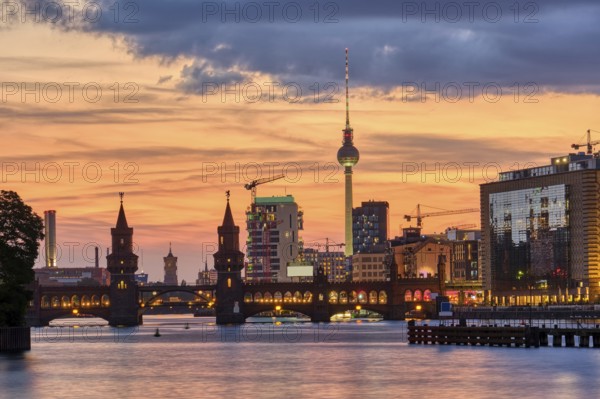 Beautiful sunset at the Oberbaum Bridge and the famous TV Tower in Berlin